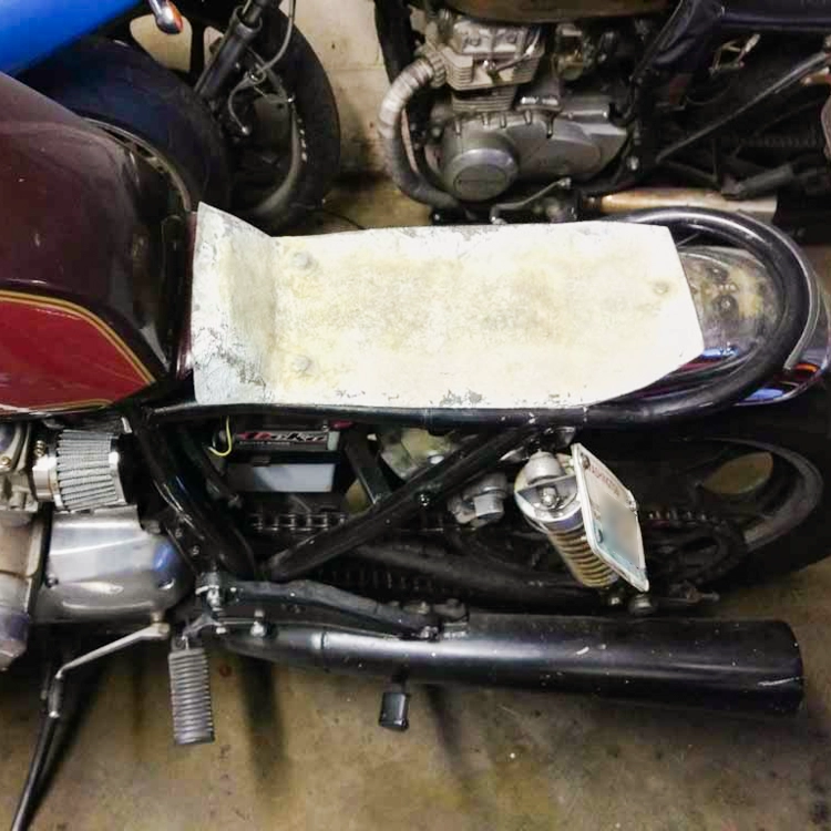 The skateboard grip tape was destroying my jeans so I decided to make a real seat. I laid masking tape over the bike frame and laid fiberglass over it to make the seat pan.