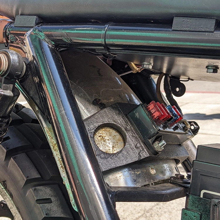 The back frame portion I cut off also had the rear fender mounts so I had to find a new way to mount the rear fender. There were some existing tabs on the frame I could use but they were too far apart. I also had to relocate the fuse box. I accomplished both by modeling and 3D printing this fuse box mount that mounts to the same frame tabs.