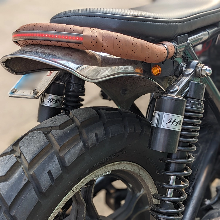 The rear turn signals are 3D printed with some standard little LED marker lights found on eBay. The new rear shocks were necessary for ride quality and safety. The leather grip tape on the tail hoop just looked nice.