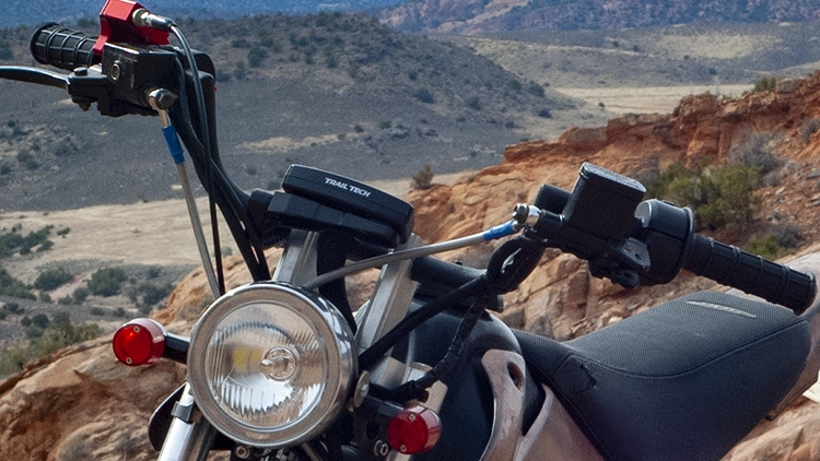 Pitbikes lack all the lights and controls of a street legal bike. I adapted various moped parts, like headlight and handlebar controls, to allow for street riding.